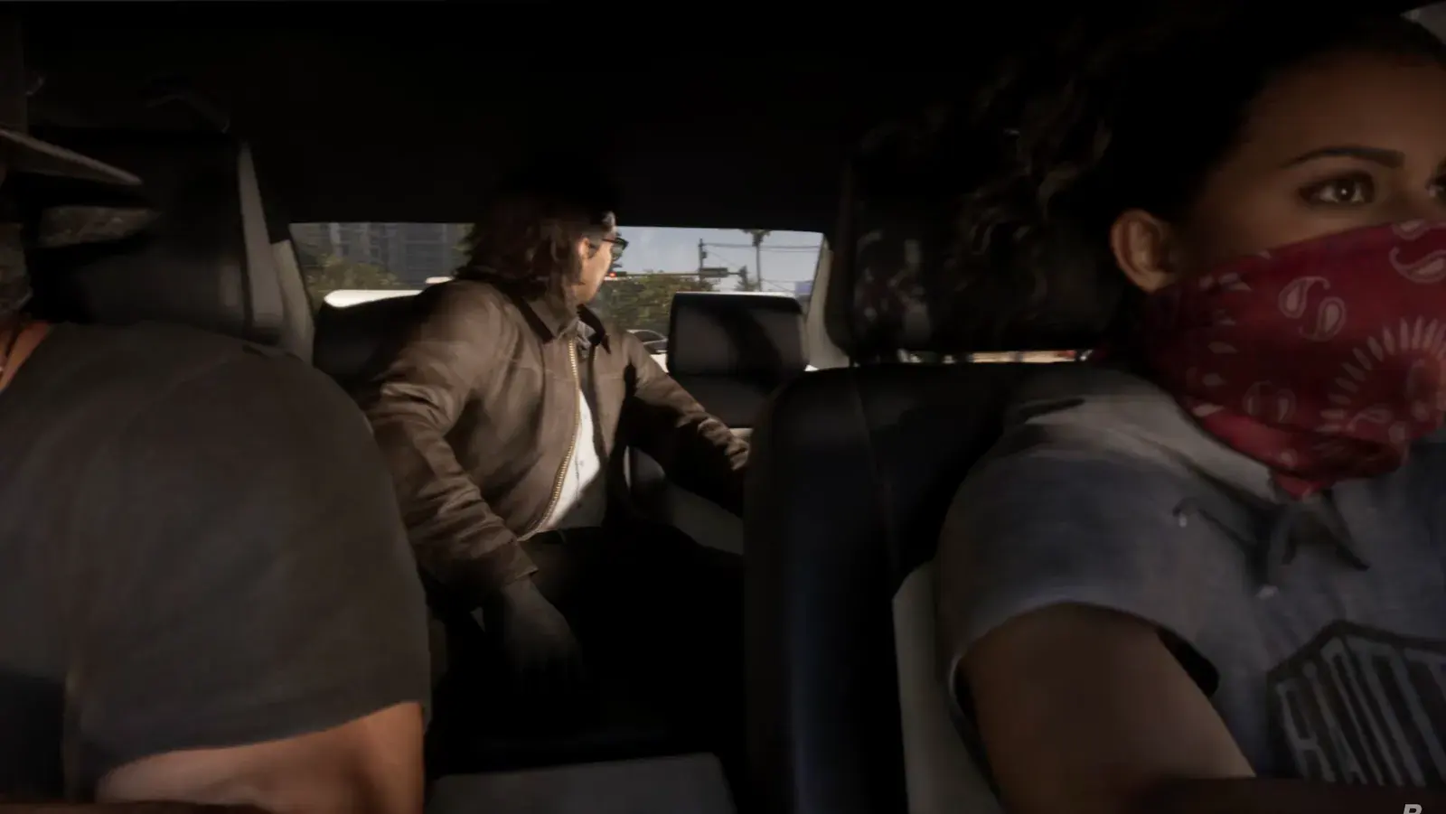 Lucia in a red bandana mask in the front seat of a car, Raul Bautista behind her