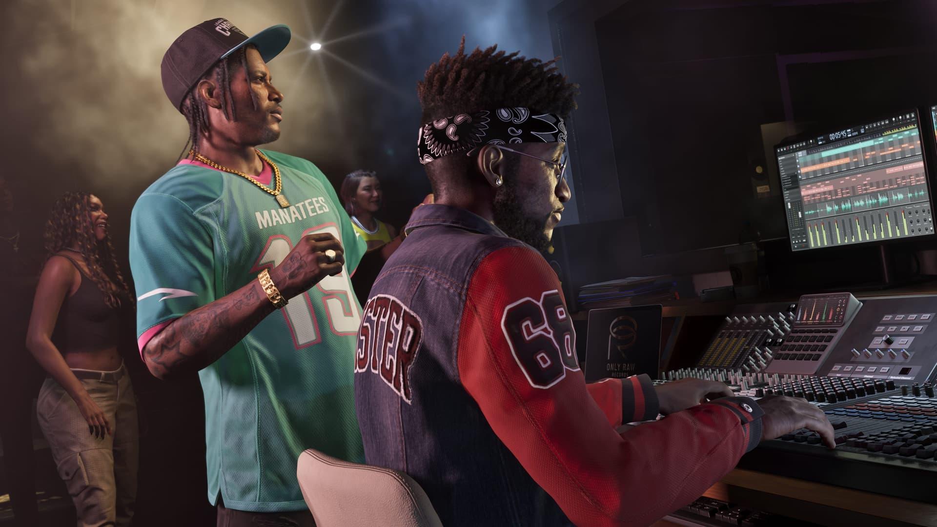 Two men in a recording studio, one in a teal football jersey and one at a mixing desk