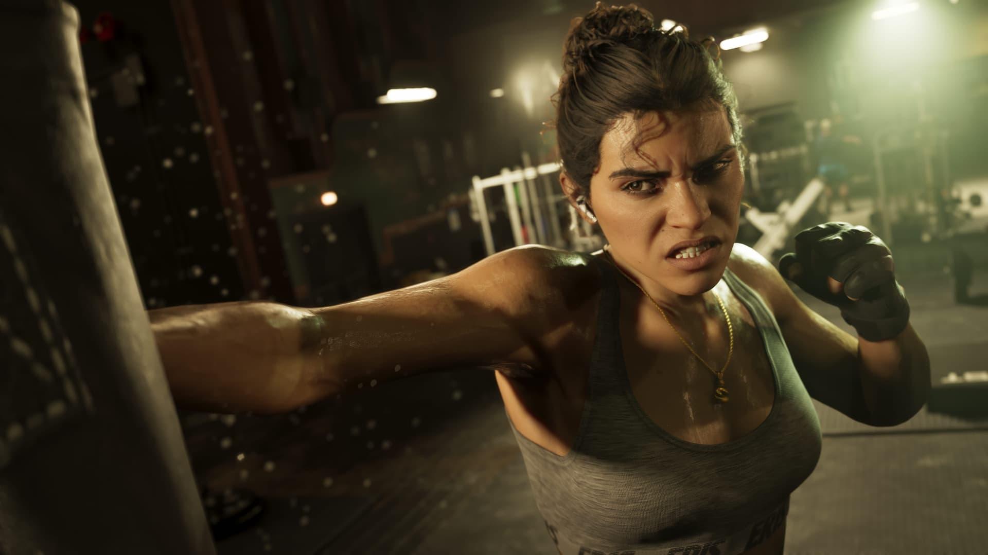 Lucia in a tank top mid-punch in a dim gym