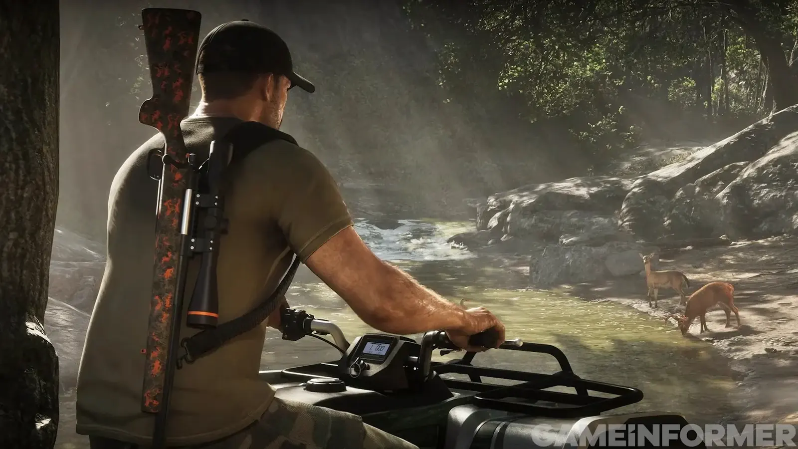 A man in a black cap on an ATV with a scoped rifle slung on his back, watching two deer drink at a rocky stream
