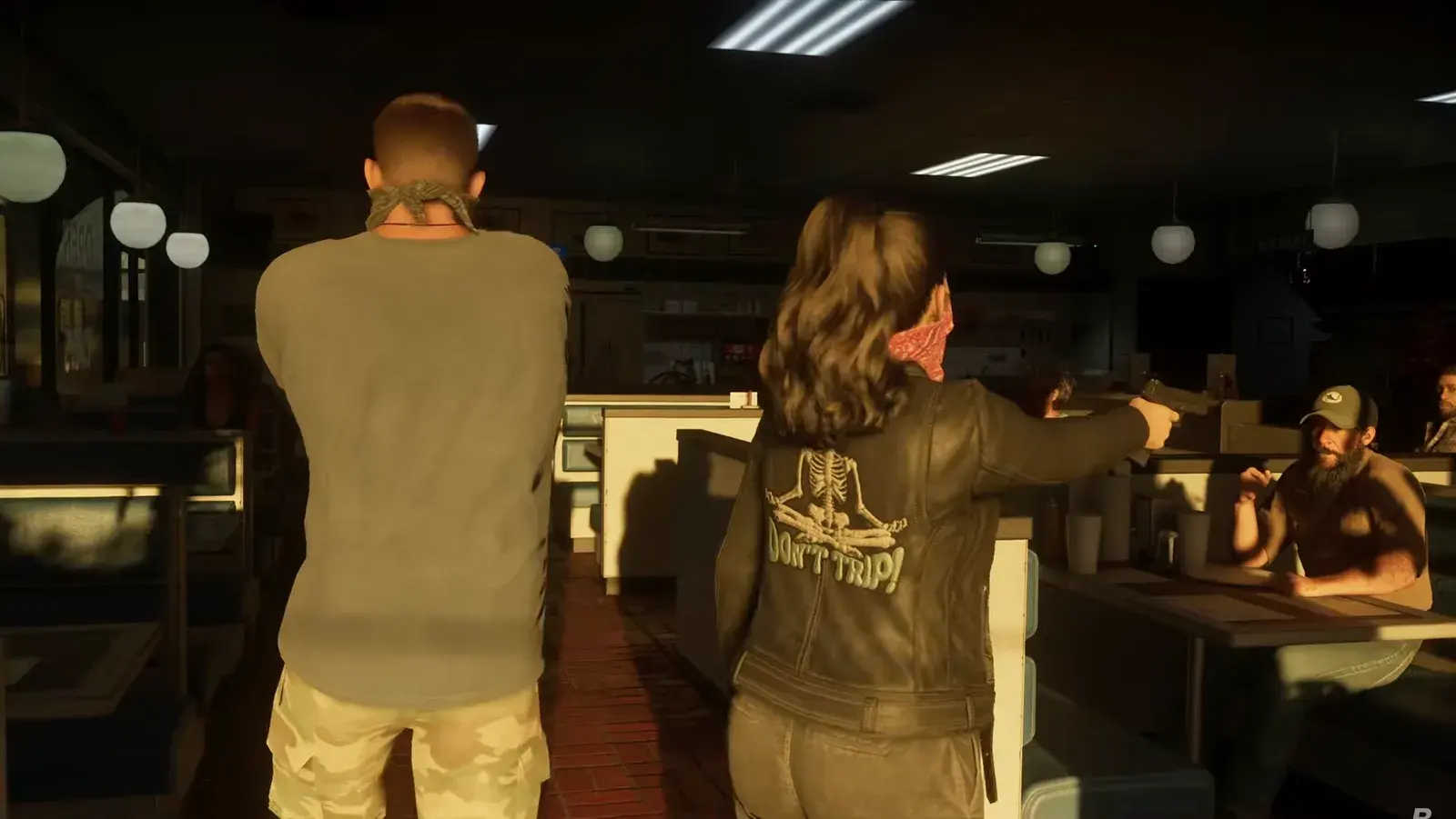 GTA 6 Extended Look frame of Jason and Lucia, both masked, holding up customers inside a dimly lit diner