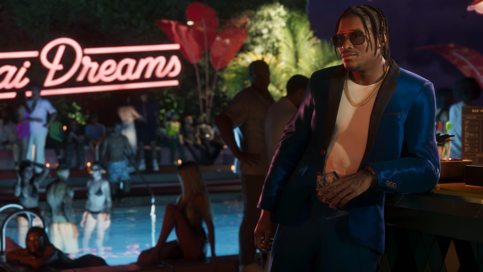 Dre'Quan Priest in completo blu appoggiato al bancone di un bar a bordo piscina, di notte, sotto un’insegna al neon, in uno screenshot ufficiale di GTA 6