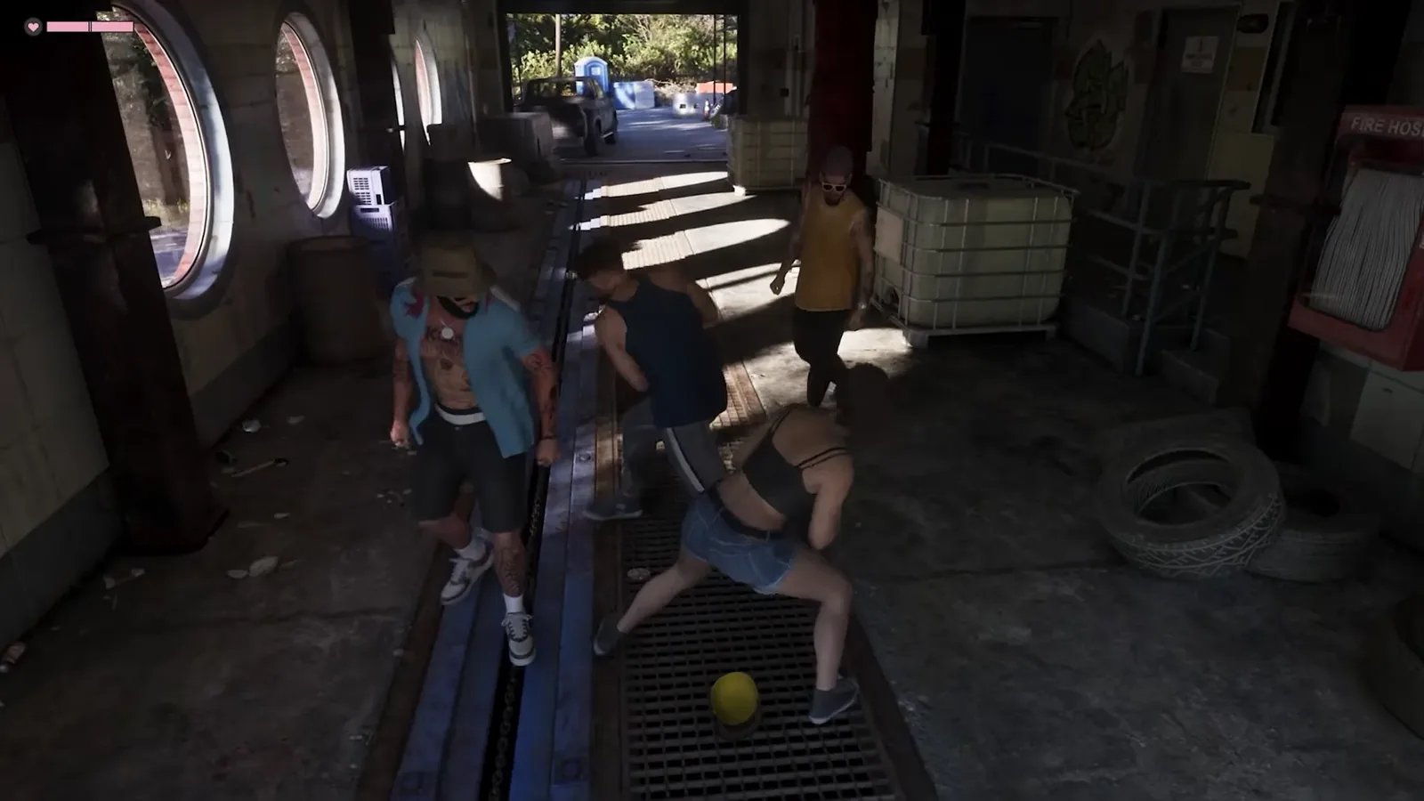 GTA 6 footage of a woman in a grey crop top and denim shorts bent over in a fight with four men in a concrete garage with a yellow hard hat on the floor grate
