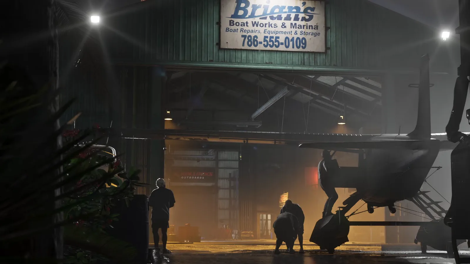Lit sign reading Brian's Boat Works and Marina with a phone number, above a hangar in GTA 6's Leonida Keys at night