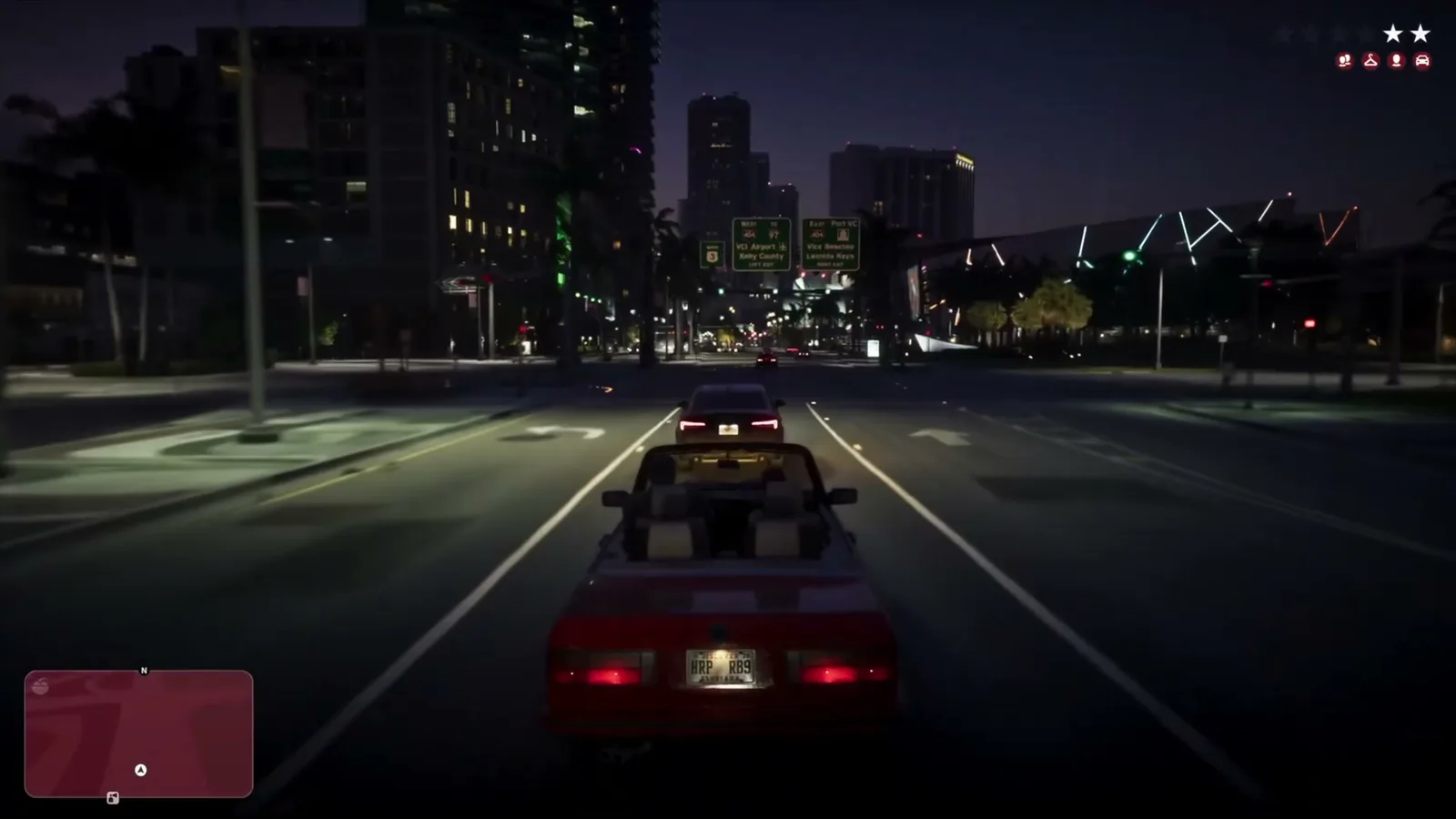 GTA 6 red convertible driving through downtown Vice City at night with a two-star wanted level in the Extended Look trailer