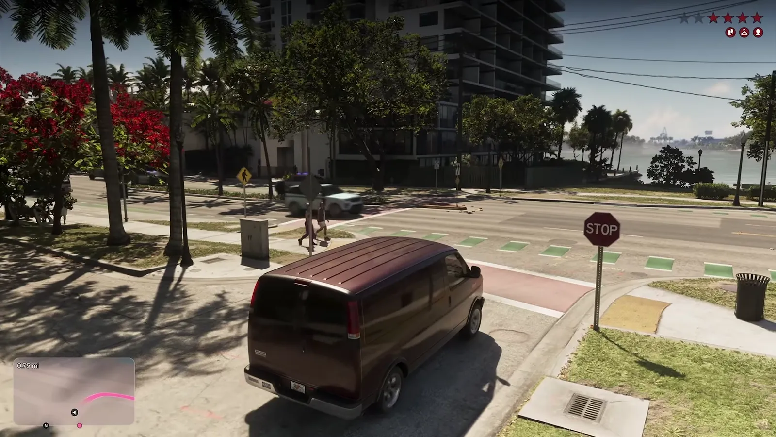 GTA 6 getaway van stopped at a stop sign as a police SUV crosses in front of it, with four red wanted stars and three icons on the HUD